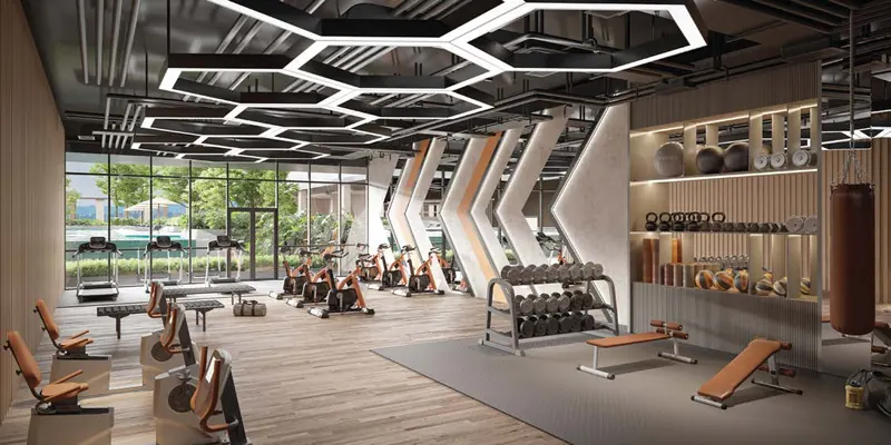 Gymnasium with weights, exercise machines and hexagonal ceiling lights