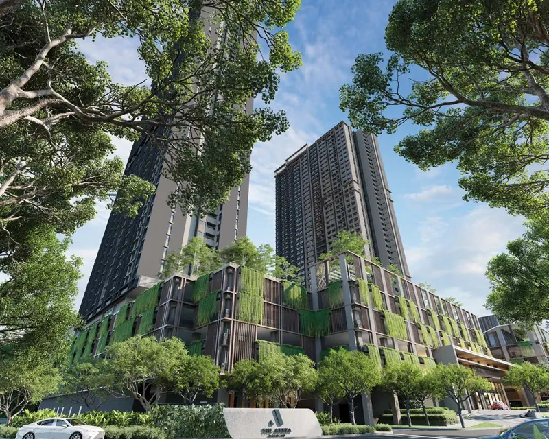 Two tall residential towers with green facades rising above trees and a landscaped entrance