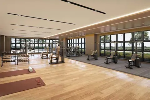 Gymnasium with exercise machines and floor-to-ceiling windows