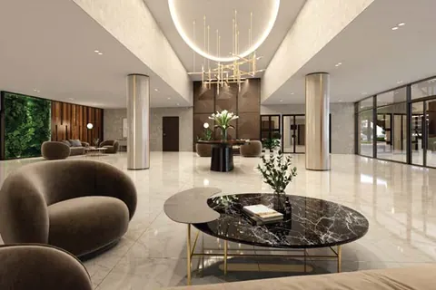Grand lobby with a chandelier, marble-topped coffee table and lounge seating